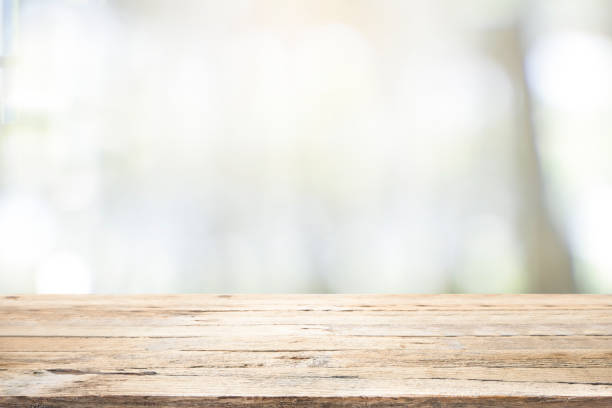 Empty wooden table for present product on coffee shop blur background.