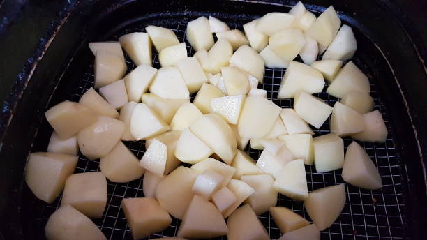 istock raw potatoes in the airfryer / deep fryer 1311821443