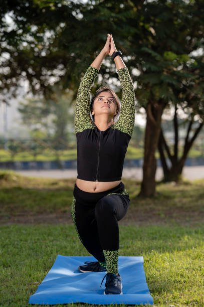 istock Young woman doing yoga and exercise in park 1311822041