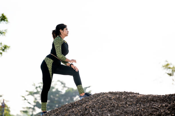 istock Young female athlete running on mountain or big rock. 1311822072