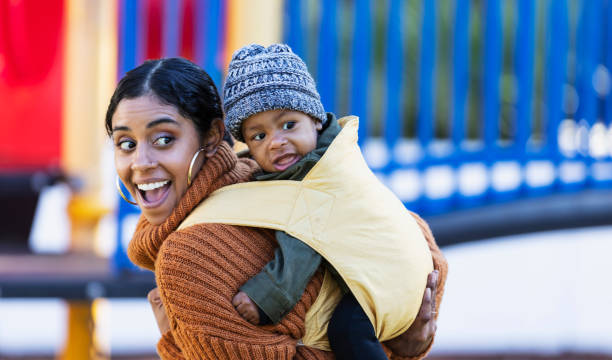 istock Mixed race mother carrying baby on her back 1311824703
