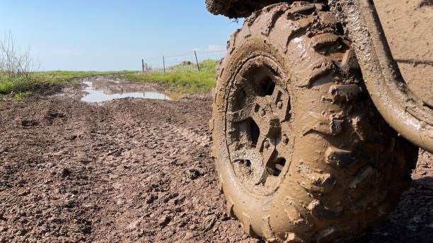 atv wheels are full of mud. travel and adventure concept. - mud dirt road road dirt imagens e fotografias de stock