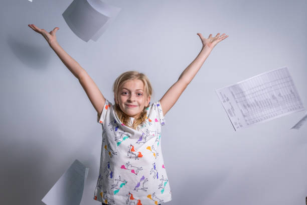 istock Girl Throwing Homework into Air 1311828462