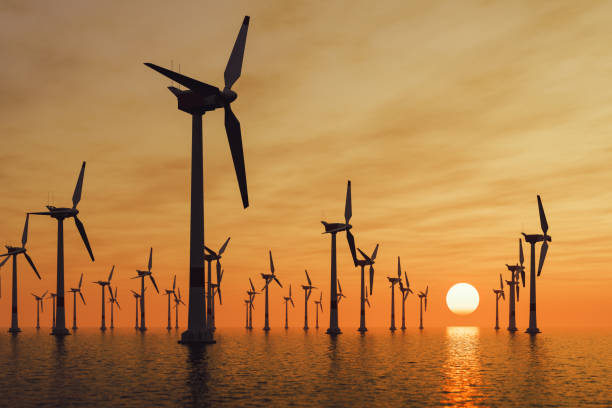 Offshore Wind Turbines At Sunset Offshore wind turbine farm at sunset. mill stock pictures, royalty-free photos & images