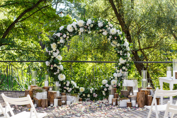 Nature theme in wedding ceremony decoration. Newlyweds arch decorated in rustic style Newlyweds arch decorated in rustic style. Wedding decoration with flowers, candles, succulents, greenery and wooden elements. Nature theme in wed ceremony decoration wedding theme stock pictures, royalty-free photos & images