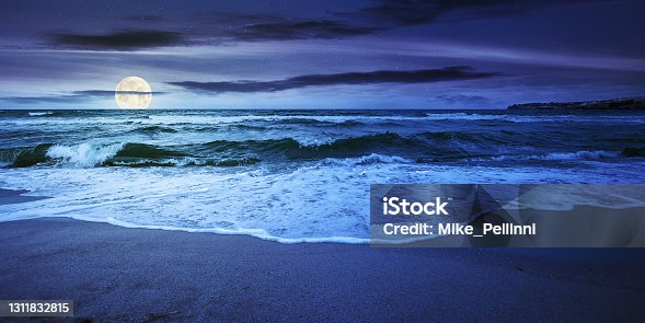 istock sea tide on a cloudy night 1311832815