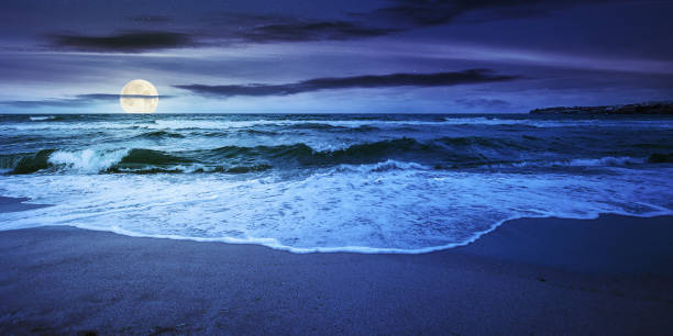 sea tide on a cloudy night stock photo