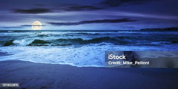 Sea Tide On A Cloudy Night Stock Photo - Download Image Now - Sea, Tide, Beach