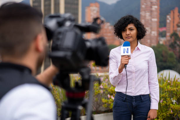 istock Journalist in front of the camera reporting breaking news 1311832981