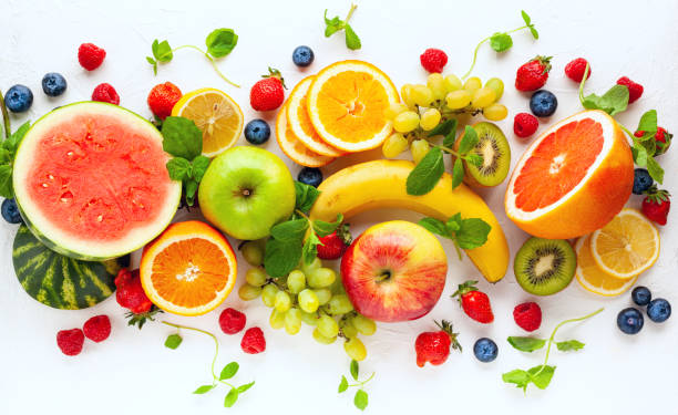 istock Assorted fresh fruits and berries on white background. 1311834609