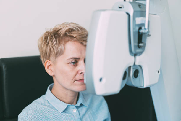 istock Woman ready for her eye test in modern opticians 1311834825