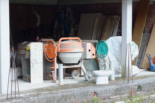istock orange and green concrete mixer under a house in construction 1311834857
