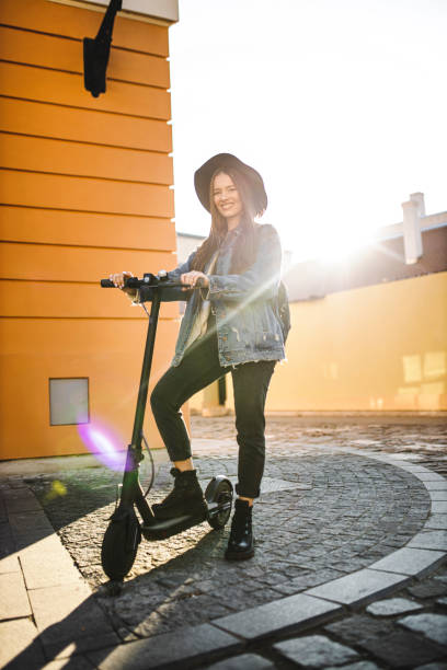 istock Young beautiful woman  riding a scooter on his way to work 1311835810