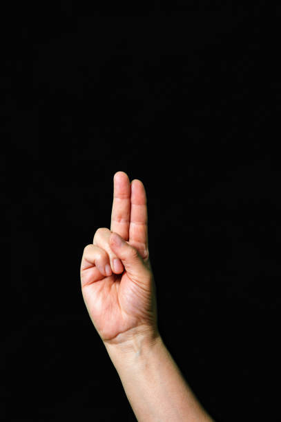 istock etter U International sign language dark background 1311839887