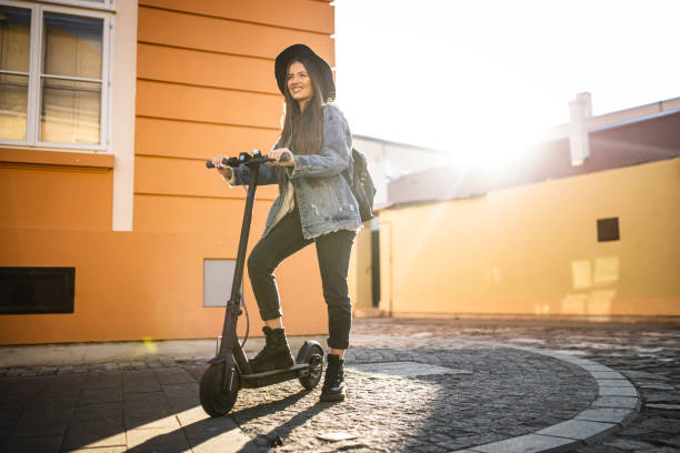 istock Young beautiful woman  riding a scooter on his way to work 1311840625
