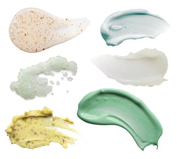 White green pink blue beige brown yellow clay cream mask sample textured foundation isolated on multi-colored background stock photo