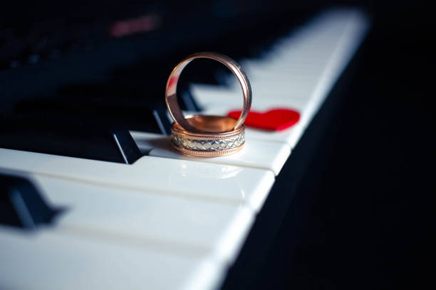 istock Two wedding rings and small heart on a piano with 1311849322