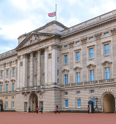 London, United Kingdom - April 9 2021: Famous and the main symbol of London Buckingham Palace and The Union Jack flag is flying at half-mast
