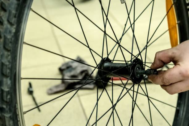 istock A mechanic repairs a bicycle wheel. 1311852436