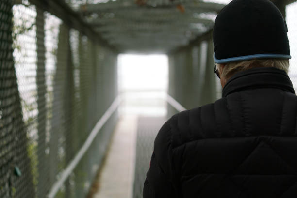 Man alone, walking through a tunnel