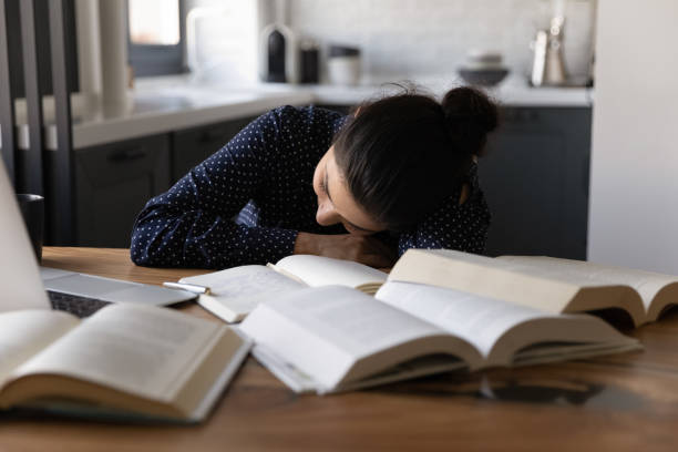 istock Close up Indian woman falling asleep at work desk 1311858450