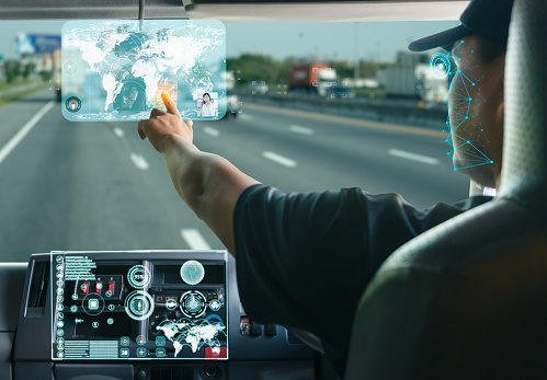 Asian truck driver searching for location on digital map realistically displayed screen and communicate with the call center team. Transport vehicle tracking technology detect driver's face and eyes.