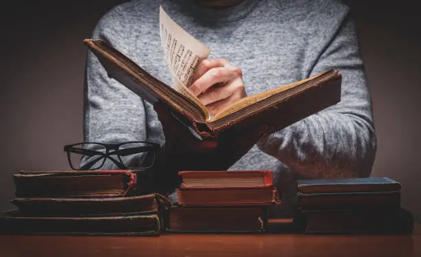 Man is Looking For Something in Old Books