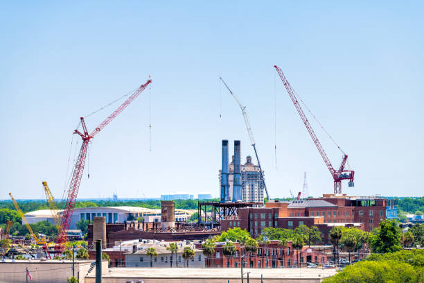 istock Savannah river waterfront with construction real estate development site by cranes and brick old town architecture in Savannah, Georgia southern city 1311860222