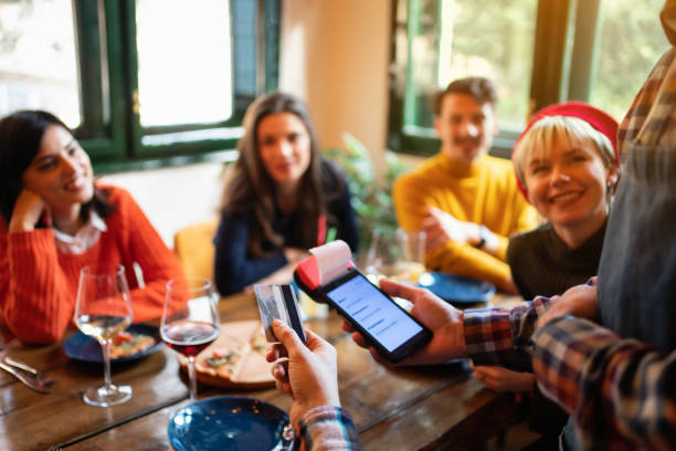 istock Man paying a lunch bill with credit card at restaurant 1311862707