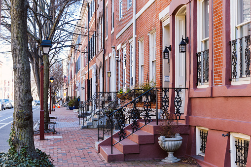 Rows of brownstone apartment buildings in Center City with windows, stoops and planters in Pennsylvania
