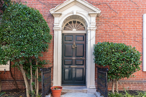 Front of brownstone apartment building in Center City with windows, stoops and planters in Philadelphia