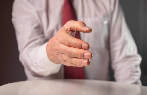 istock Businessman outsretched his hand for handshake to camera 1311870331