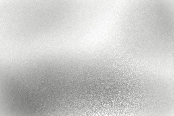 istock Light shining on silver scratch metal wall with copy space, abstract texture background 1311871190