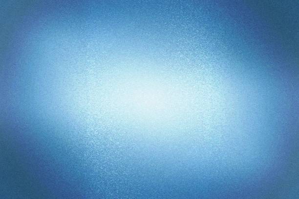 istock Light shining on dark blue scratch metal wall with copy space, abstract texture background 1311871191