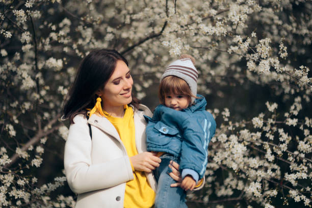 istock Happy Mother and Child in Blooming Spring Nature 1311874977