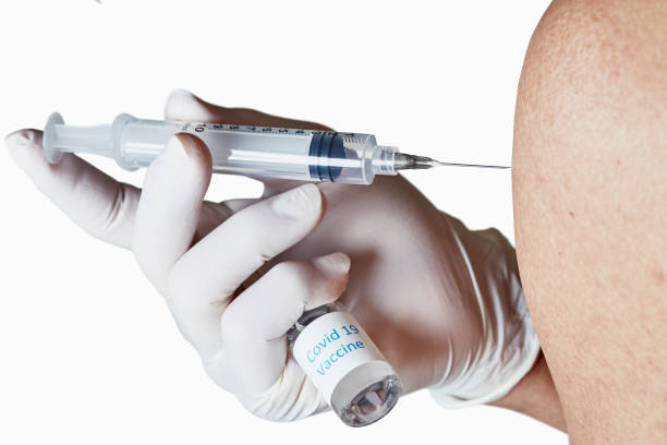 istock Gloved hand administering an Injection in the Arm 1311878238