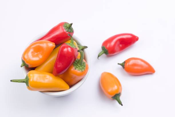 istock Overview of peppers on white. 1311878947