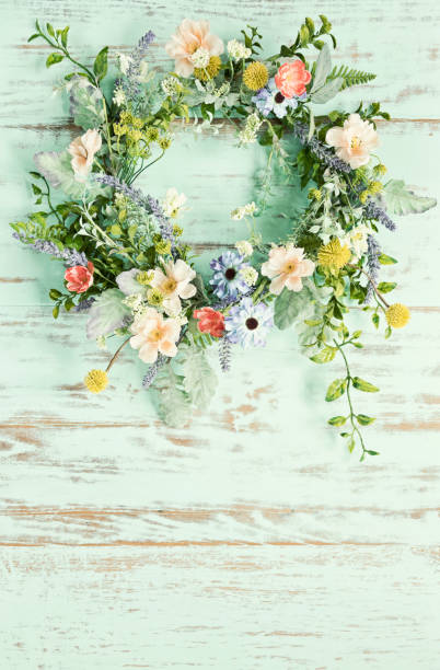 istock Spring flower wreath on an old rustic wood background 1311879847