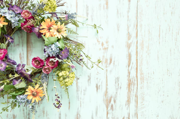 istock Spring flower wreath on an old rustic wood background 1311879854