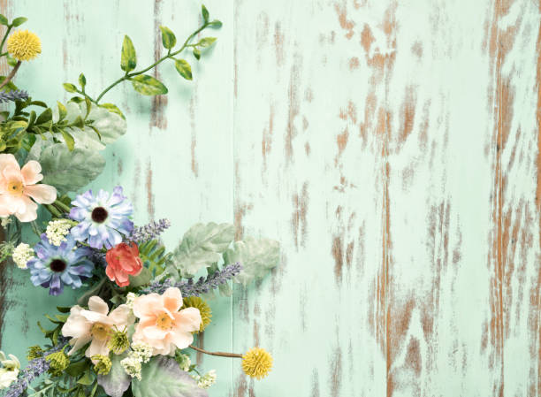 istock Spring flower wreath on an old rustic wood background 1311879860