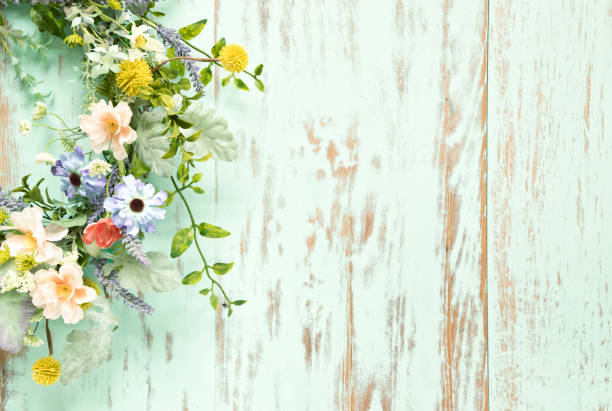 istock Spring flower wreath on an old rustic wood background 1311879869