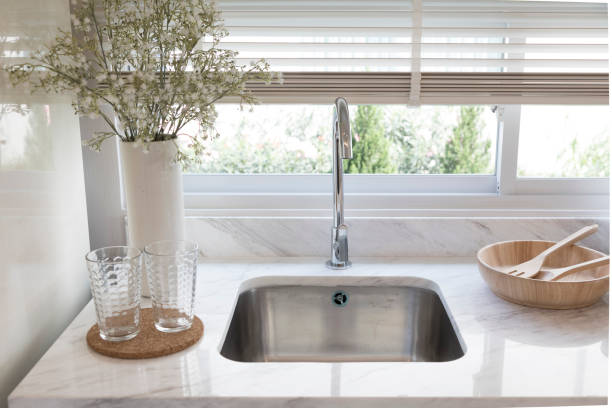 istock Clean new sink in stylish kitchen interior by the window. 1311880520