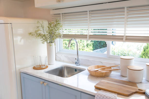 istock Clean new sink in stylish kitchen interior by the window. 1311880522