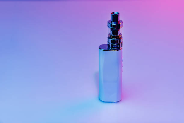 istock electric cigar is steam-making device designed for inhalation. in colored light 1311890174