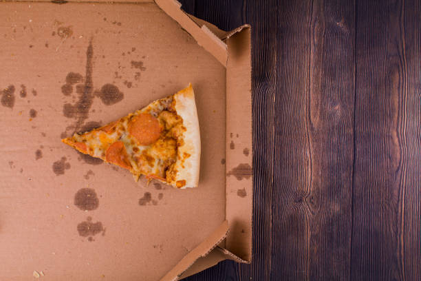 istock last slice of salami pizza in a box 1311891354