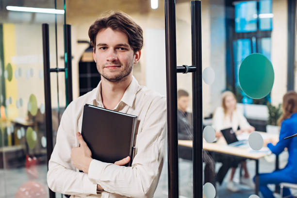 istock Portrait of businessman holding folder 1311892059