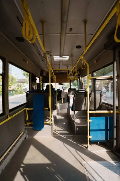 An empty public transport vehicle. Empty seats of a trolleybus. No one is sitting in the bus.