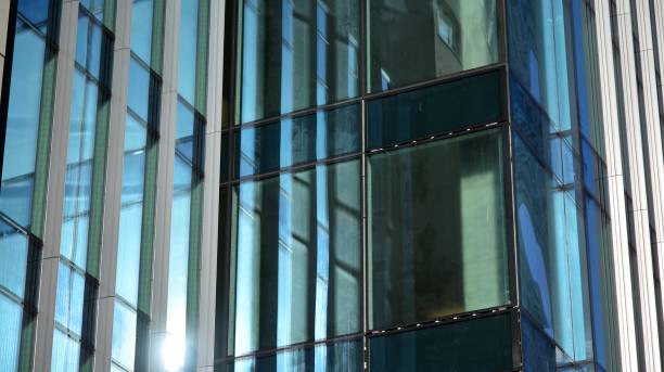 istock Modern office building with glass facade on a clear sky background. 1311894837