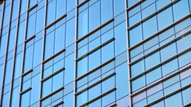 istock Modern office building with glass facade on a clear sky background. 1311895028