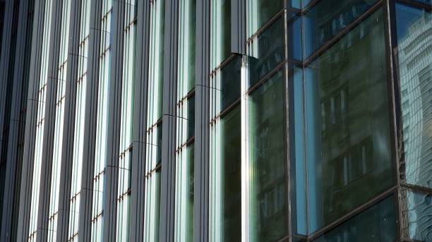 istock Modern office building with glass facade on a clear sky background. 1311895105